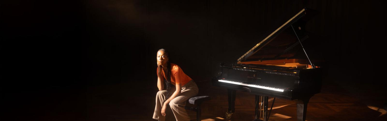 Jeneba Kanneh Mason sitting at a piano