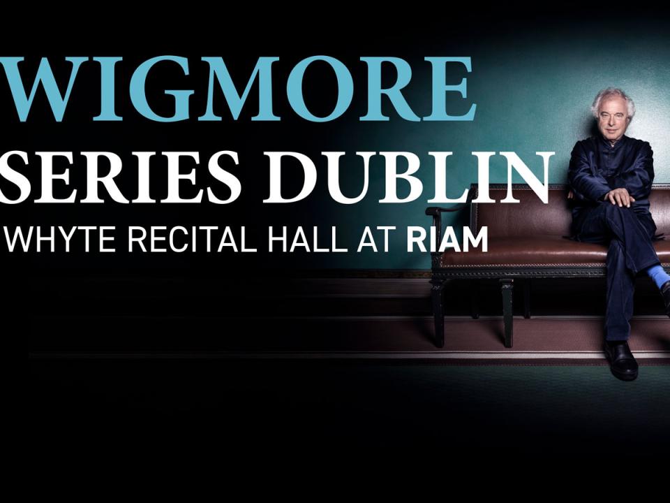 Pianist András Schiff sits on a red leather antique sofa with wooden arms and feet against a gradient turquoise to black background, crossing his legs and folding his arms in his lap. The image is overlaid with the title 'Wigmore Series Dublin. Whyte Recital Hall is at RIAM and features the RIAM logo and Clinch Wealth Management logo. 