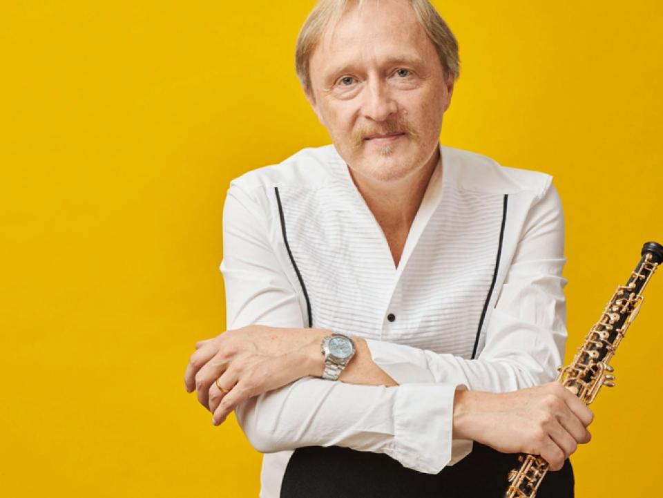 Albrecht Mayer on bright yellow background