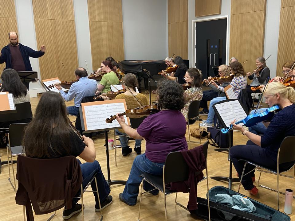 A collection of string orchestra members performing in the Vernon Studio