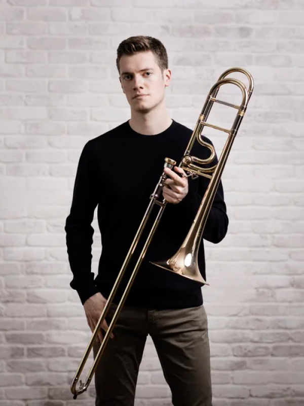 Peter Moore, trombonist starting with his instrument facing the camera