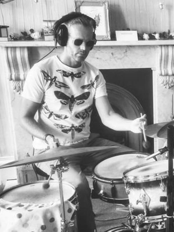 Dr. Stephen Davis wears shades and plays a drum kit