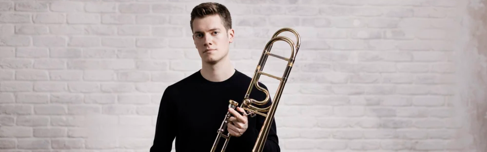 Peter Moore, trombonist starting with his instrument facing the camera