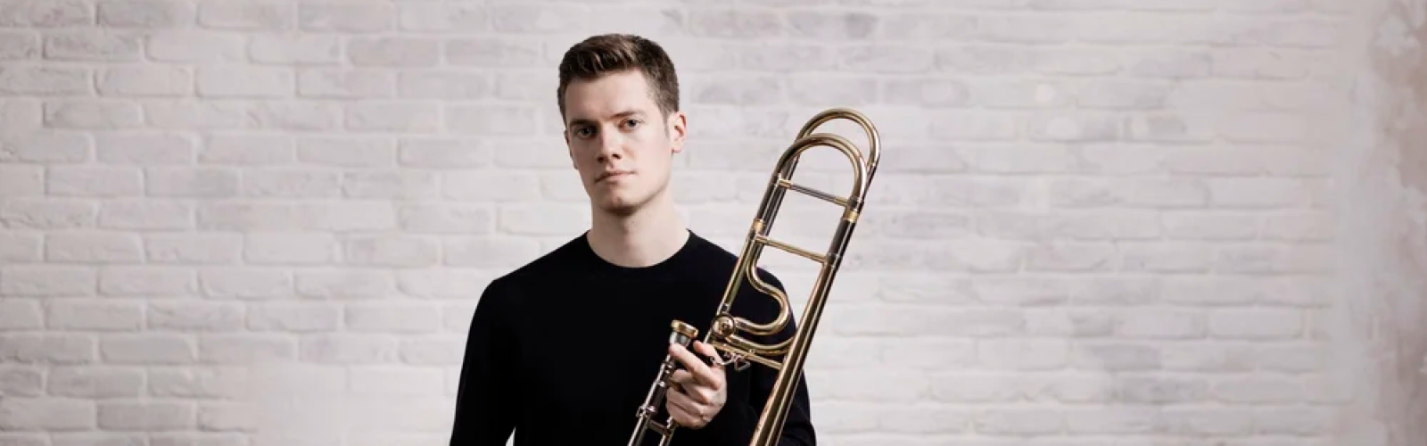 Peter Moore, trombonist starting with his instrument facing the camera
