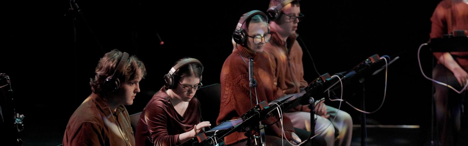 When Forests Sing Production Shot - Performaers sit at iPads in the Samuel Backett Theatre