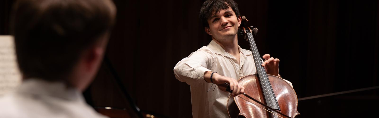 Cellist performing on stage at the Whyte Recital Hall. Open Day 2026